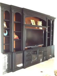 Entertainment center with open backing that shows painted wall