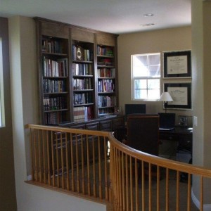 Built in desk and bookshelves in home office loft.