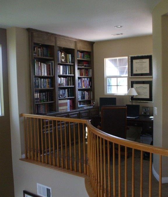 Built in desk and bookshelves in home office loft.